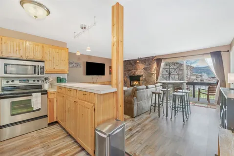a kitchen with a table chairs stove and cabinets