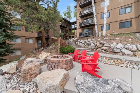 a view of a terrace with furniture and a garden