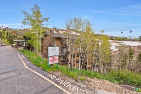 a view of a house with a backyard space and balcony