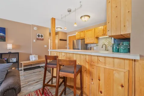 a kitchen with stainless steel appliances kitchen island granite countertop a table and chairs
