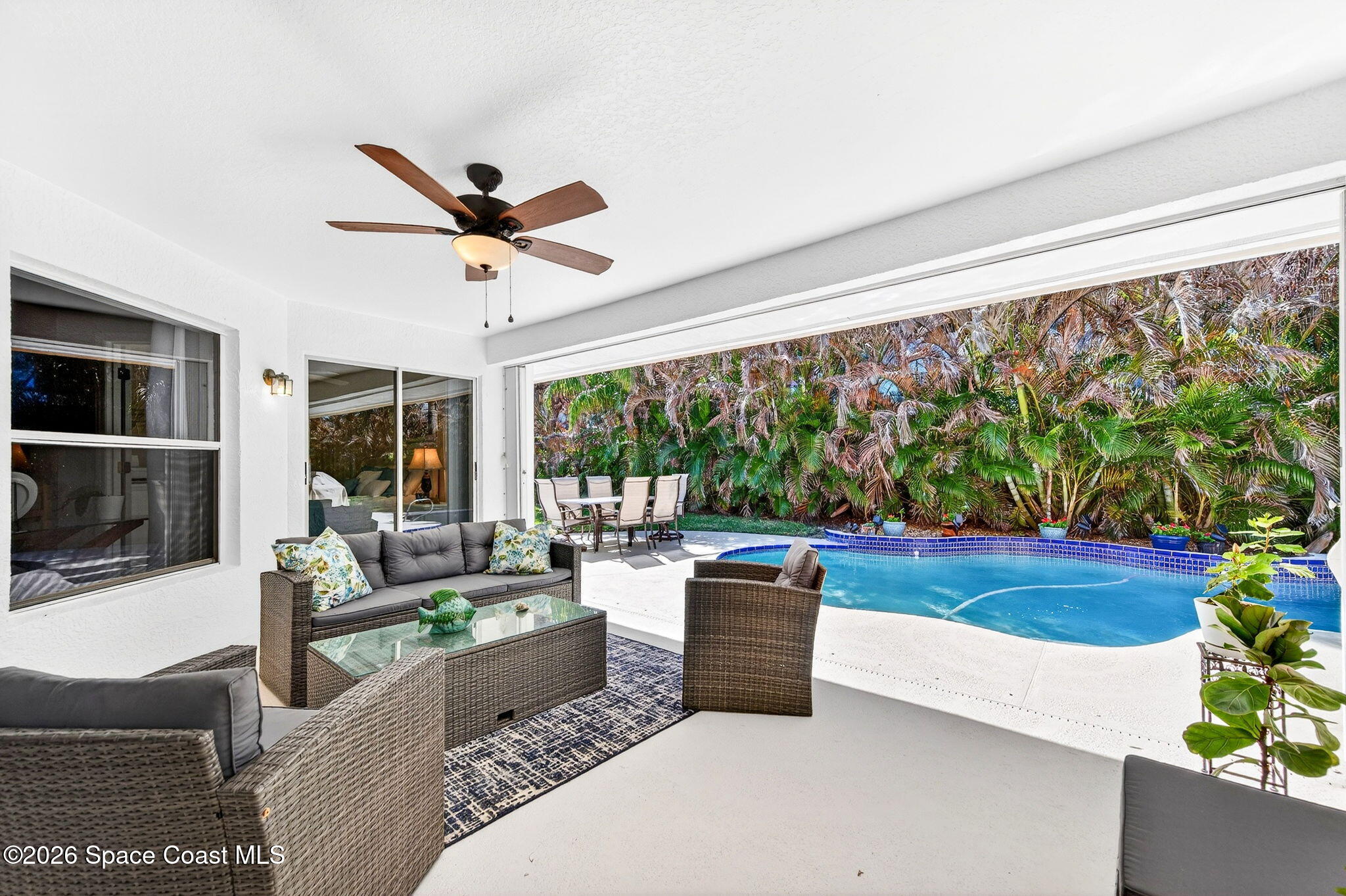 121 Ocean Ridge Drive Melbourne Beach, FL 32951 - Photo 11 of 41 a living room with furniture and a large window