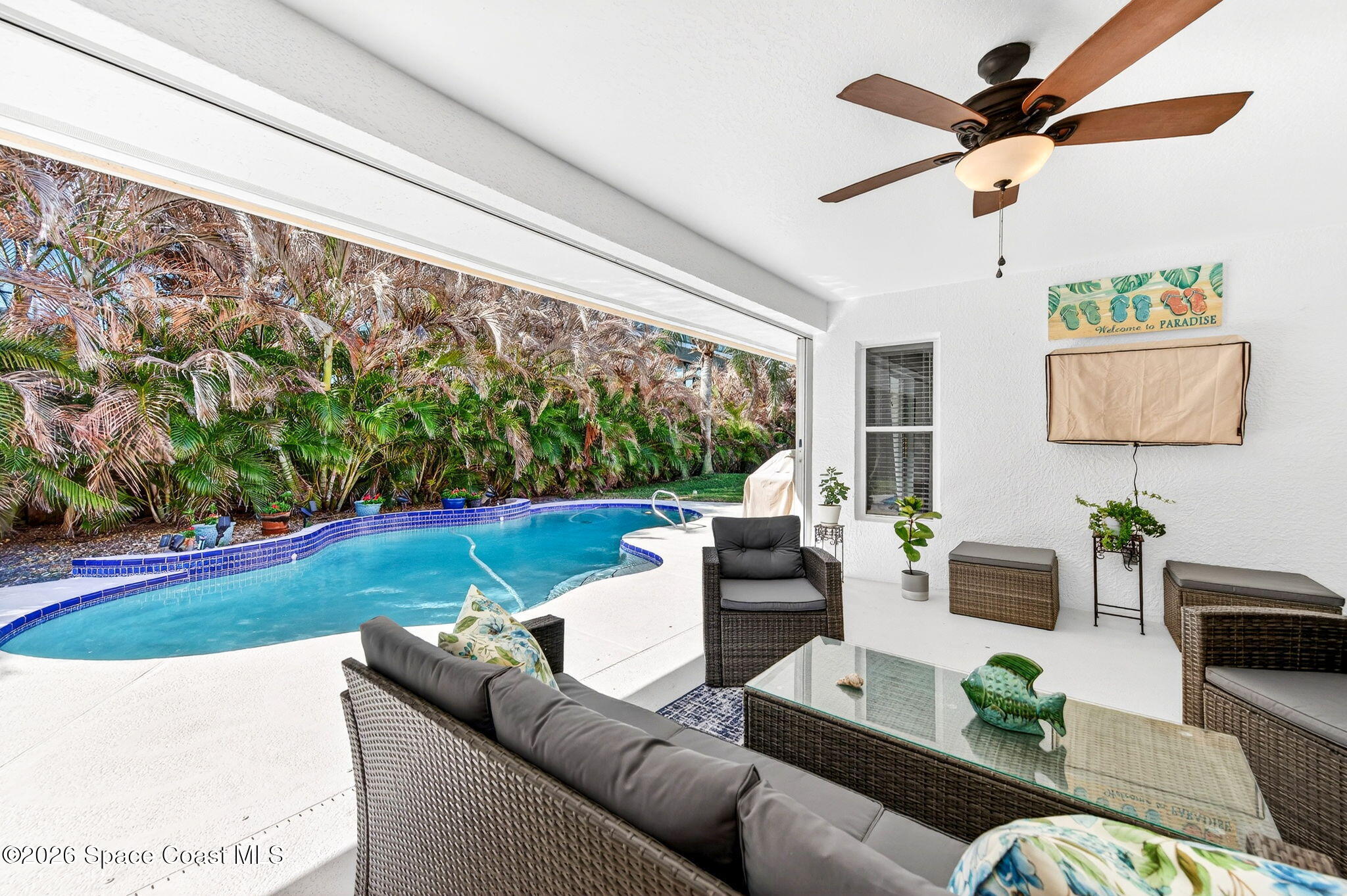 121 Ocean Ridge Drive Melbourne Beach, FL 32951 - Photo 12 of 41 a living room with patio furniture and a potted plant