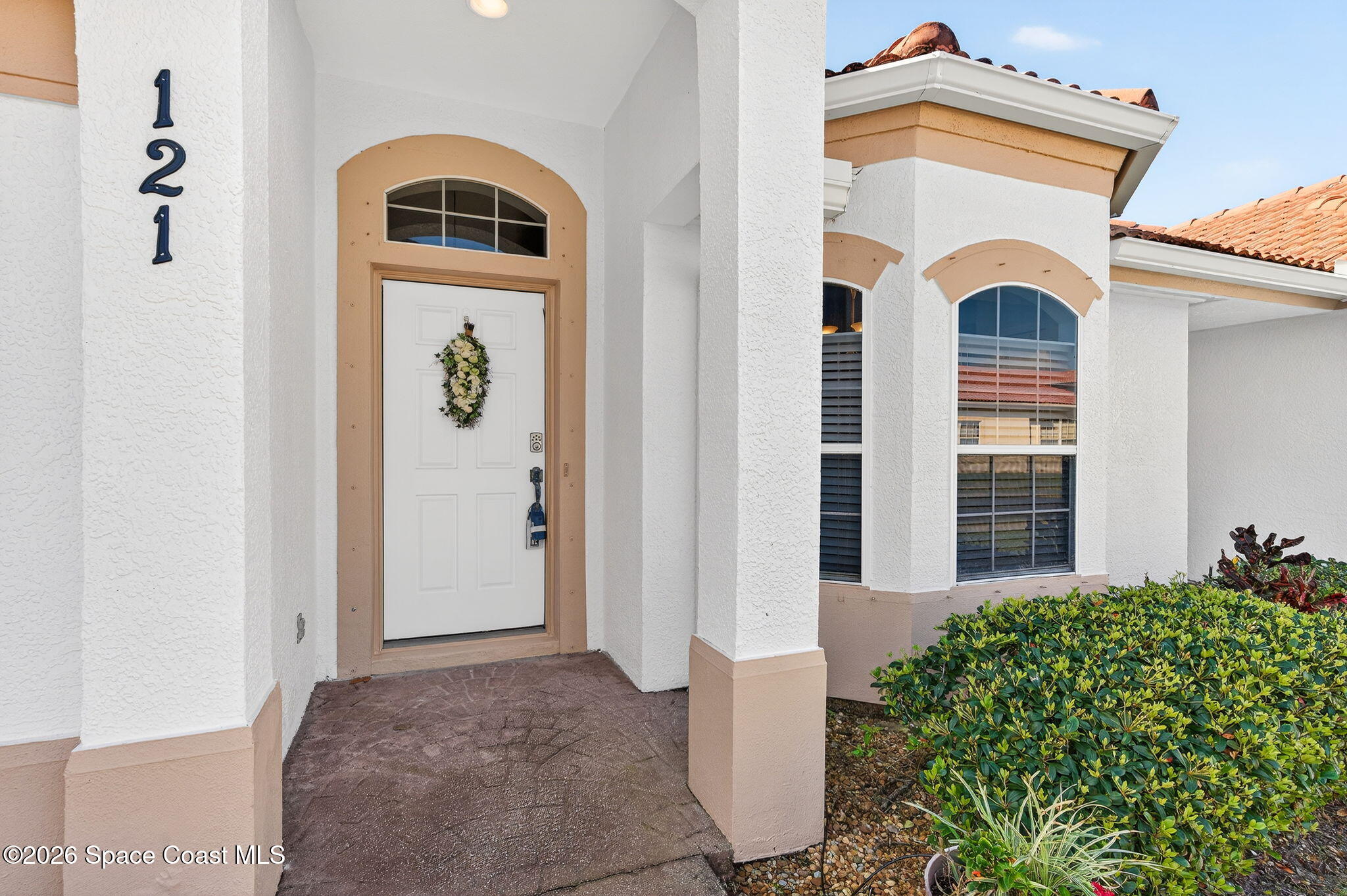 121 Ocean Ridge Drive Melbourne Beach, FL 32951 - Photo 24 of 41 a front view of a house with garden