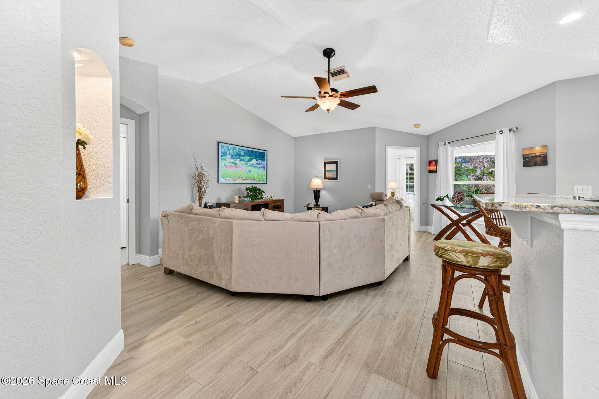 121 Ocean Ridge Drive Melbourne Beach, FL 32951 - Photo 26 of 41 a living room with furniture and a wooden floor
