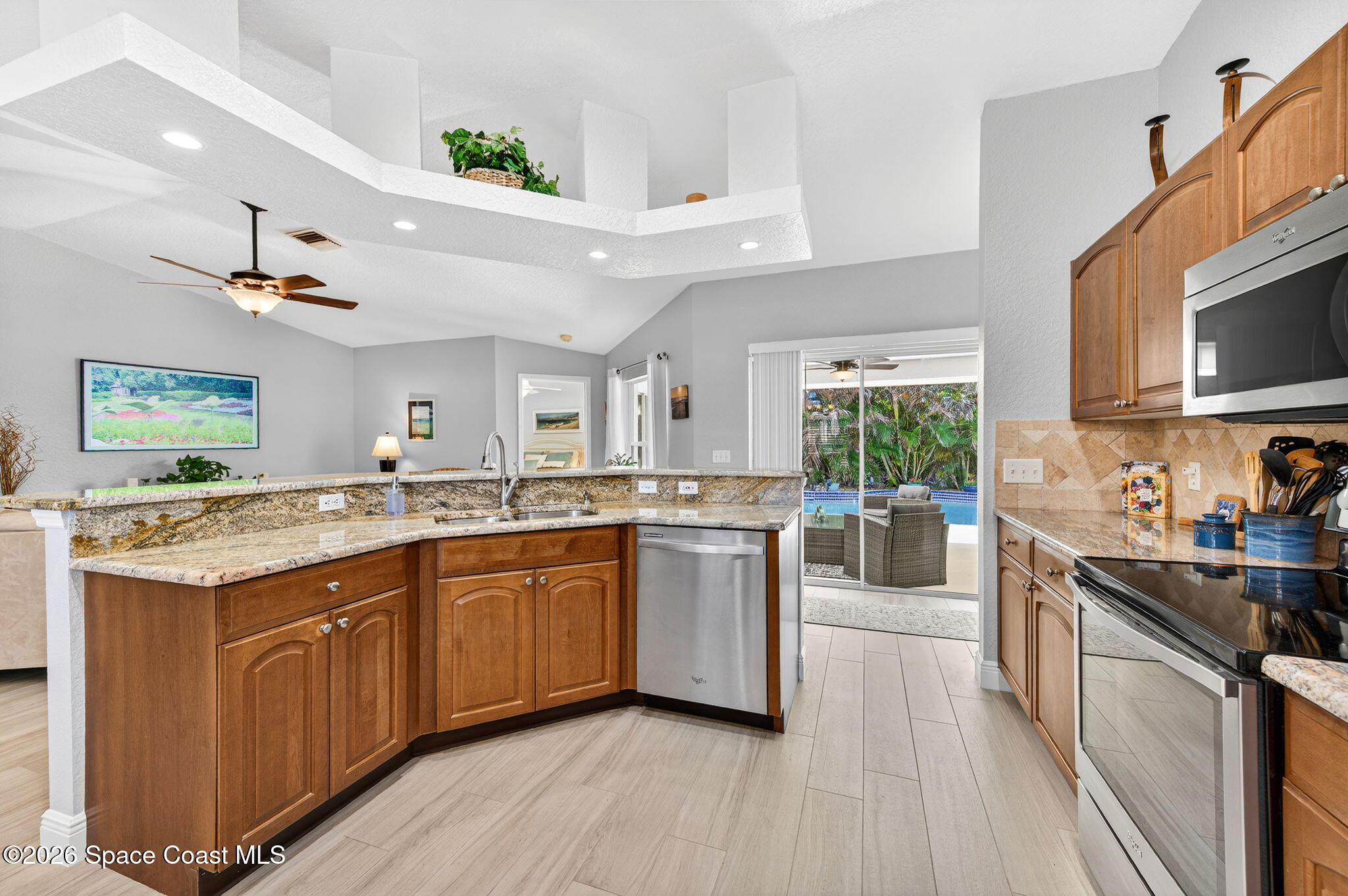 121 Ocean Ridge Drive Melbourne Beach, FL 32951 - Photo 31 of 41 a kitchen with stove a sink and cabinets