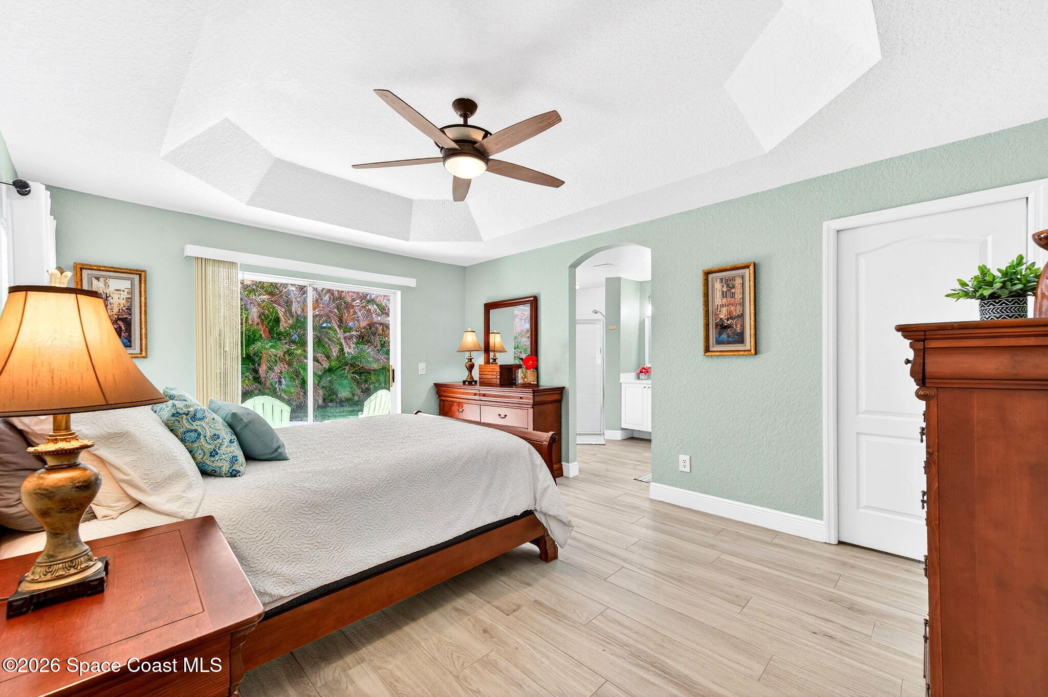 121 Ocean Ridge Drive Melbourne Beach, FL 32951 - Photo 32 of 41 a bedroom with a bed and wooden floor