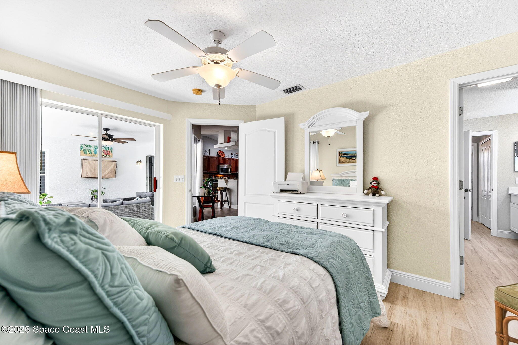 121 Ocean Ridge Drive Melbourne Beach, FL 32951 - Photo 36 of 41 a bedroom with a large bed and a chandelier