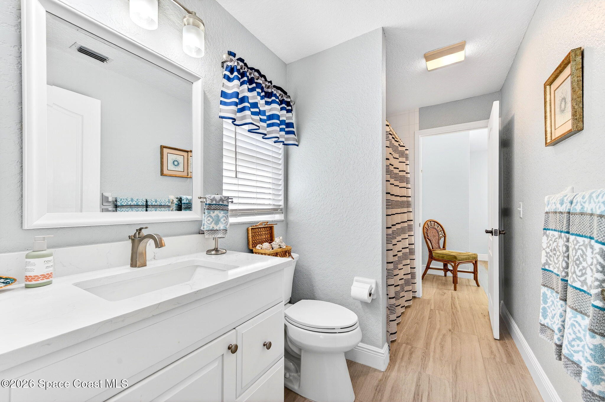 121 Ocean Ridge Drive Melbourne Beach, FL 32951 - Photo 37 of 41 a bathroom with a sink a toilet and a mirror