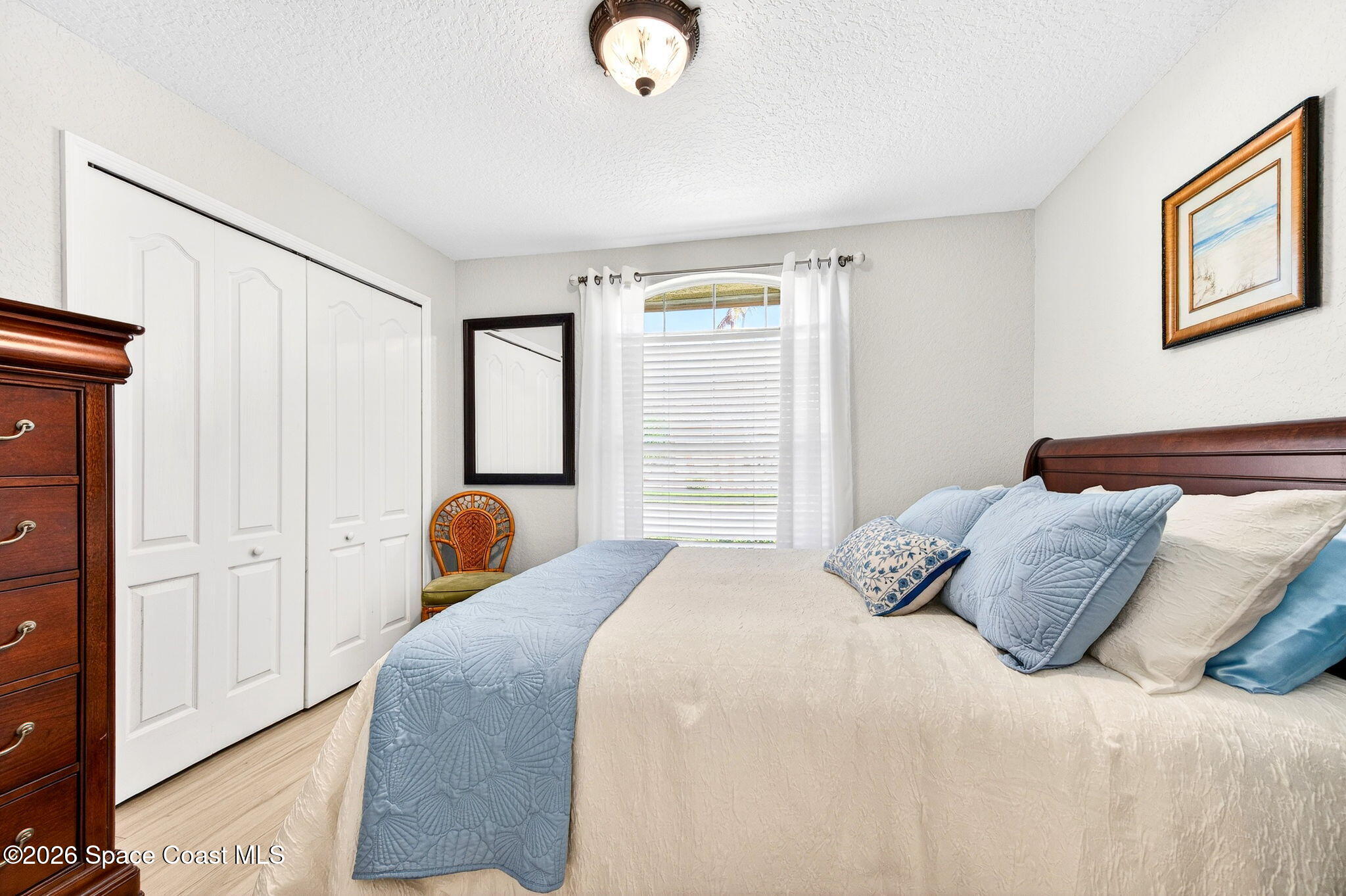 121 Ocean Ridge Drive Melbourne Beach, FL 32951 - Photo 38 of 41 a bedroom with a bed and wooden floor