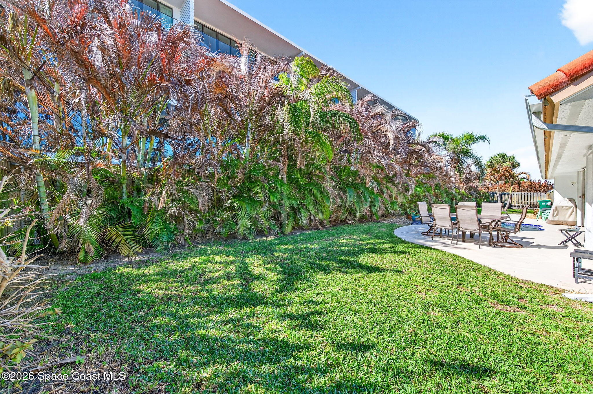 121 Ocean Ridge Drive Melbourne Beach, FL 32951 - Photo 9 of 41 a view of a backyard with plants and a patio