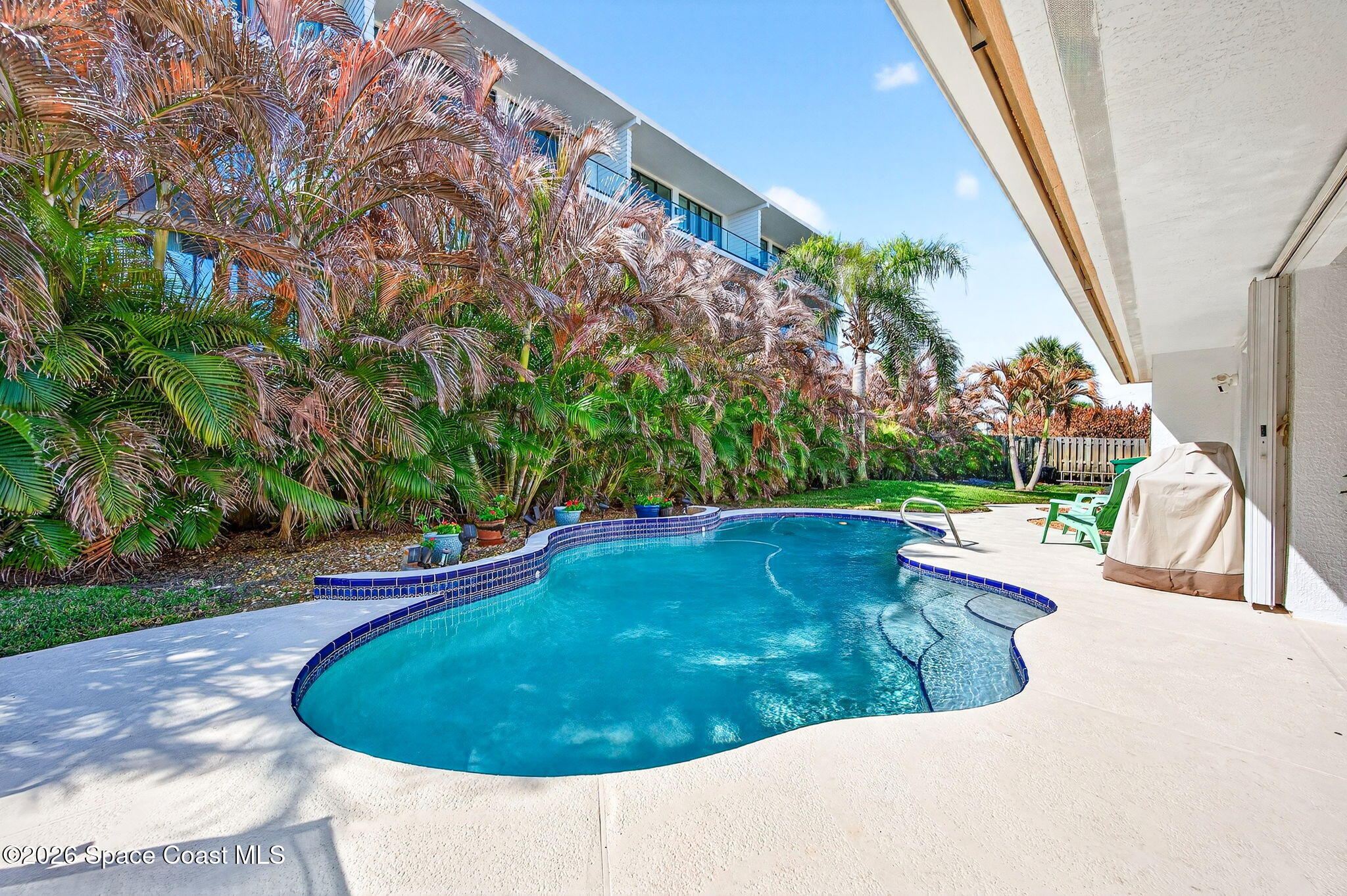 121 Ocean Ridge Drive Melbourne Beach, FL 32951 - Photo 10 of 41 a view of a swimming pool with a yard and plants