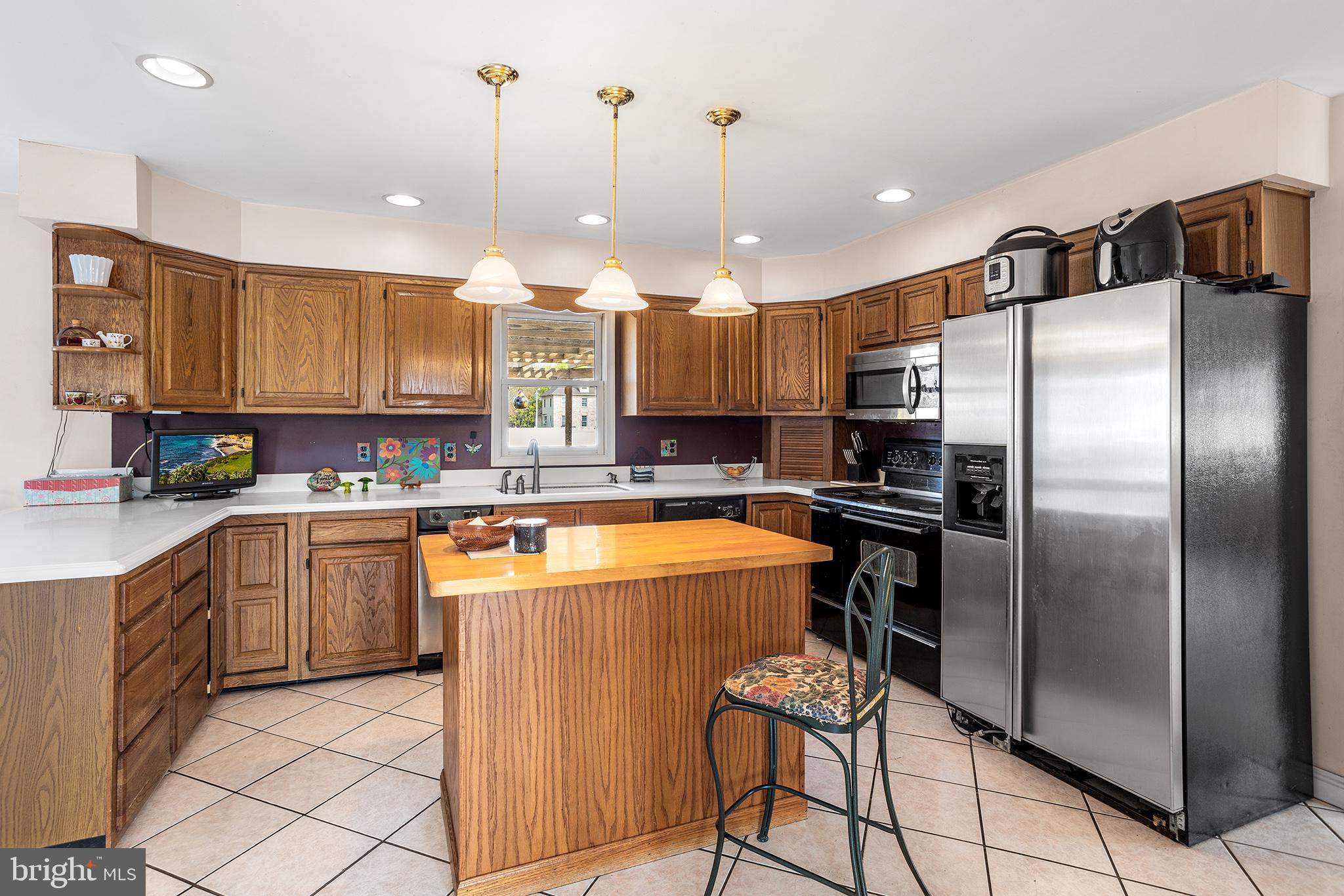 200 Casperson Street Gibbstown, NJ 08027 - Photo 14 of 64 a kitchen with stainless steel appliances granite countertop a refrigerator a sink a stove a dining table and chairs