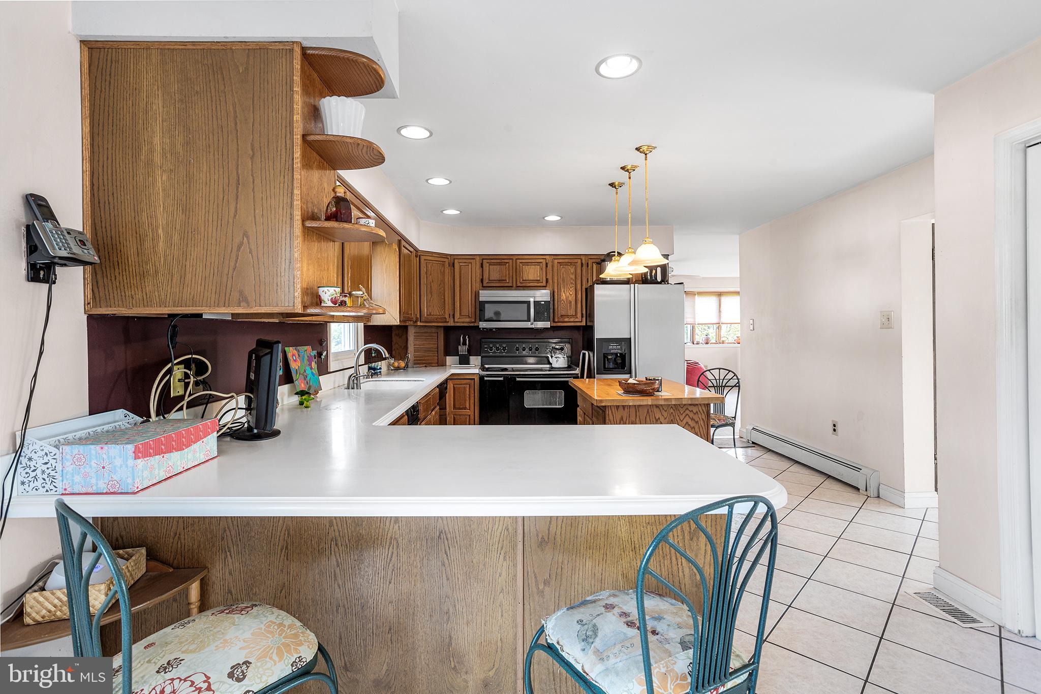 200 Casperson Street Gibbstown, NJ 08027 - Photo 16 of 64 a kitchen with a sink a stove and chairs