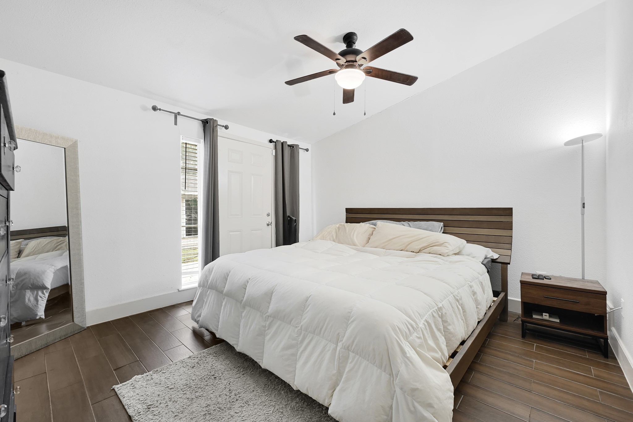 207 Wafer Street Pasadena, TX 77506 - Photo 13 of 26 a bedroom with a large bed and a chandelier