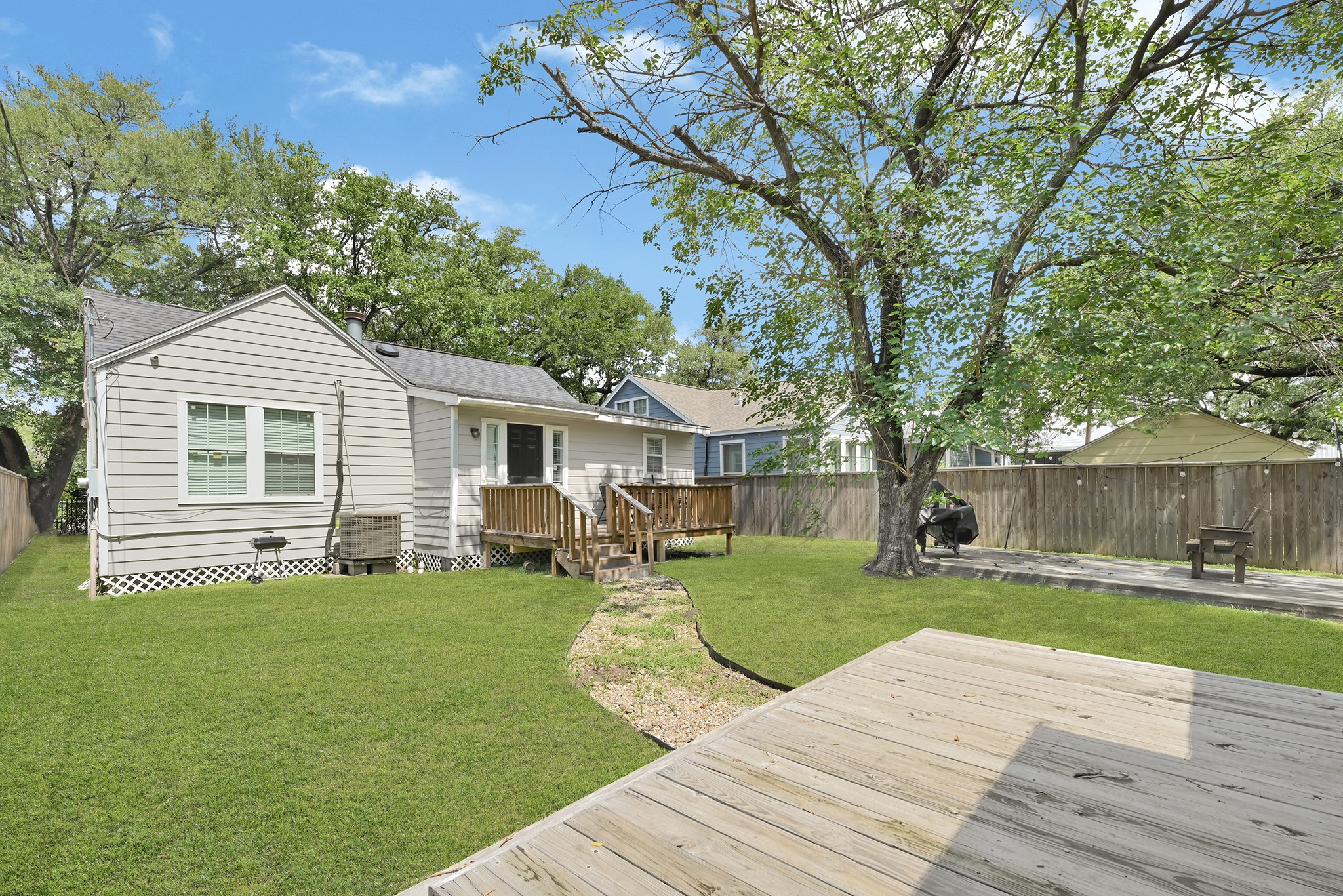 207 Wafer Street Pasadena, TX 77506 - Photo 24 of 26 a front view of a house with a yard and trees