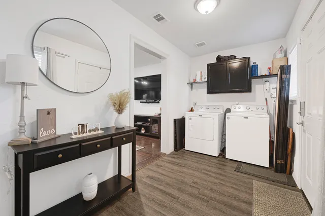 a view of a workspace with mirror cabinet and a window