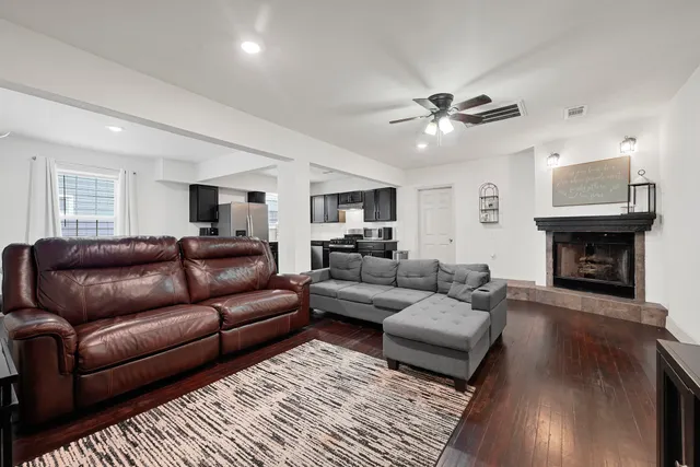 a living room with furniture and a fireplace