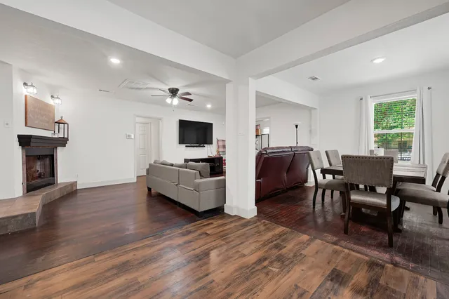 a living room with furniture flat screen tv and fireplace