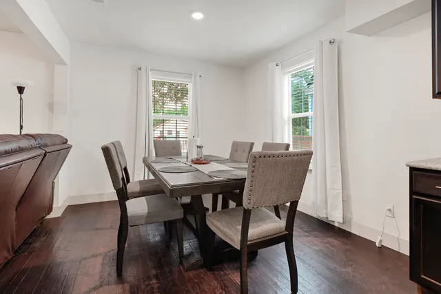 a view of a dining room with furniture window and wooden floor