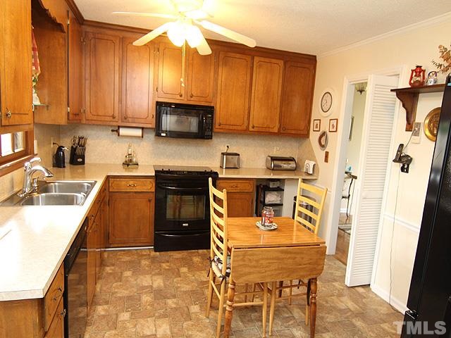 5522 Earl Road Durham, NC 27712 - Photo 6 of 13 a kitchen with stainless steel appliances granite countertop a sink a stove and refrigerator