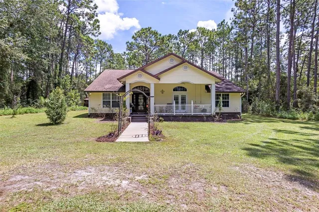 a view of a house with a yard patio and swimming pool