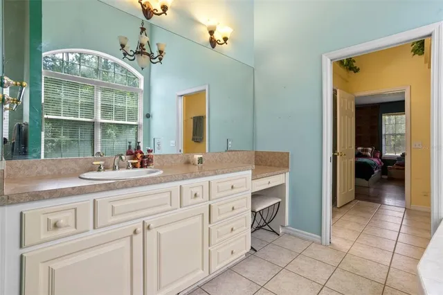a bathroom with a granite countertop toilet and a sink