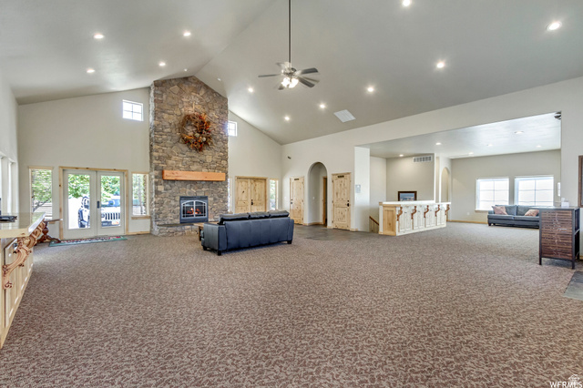 3598 North Huntsman Path, Unit 502 Eden, UT 84310 - Photo 26 of 43 Living area with a high ceiling, a fireplace, carpet, a ceiling fan, and recessed lighting