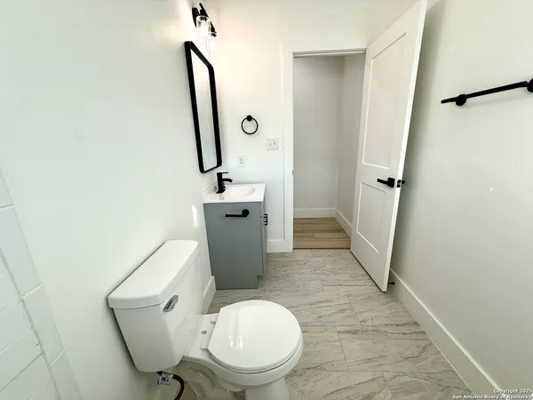 a white toilet sitting next to a bathroom sink