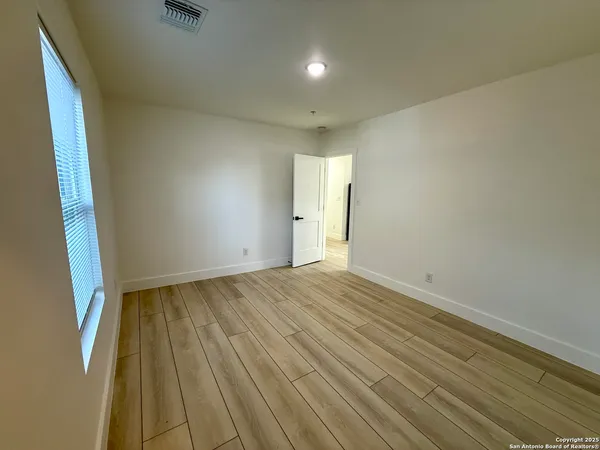 a view of an empty room and wooden floor