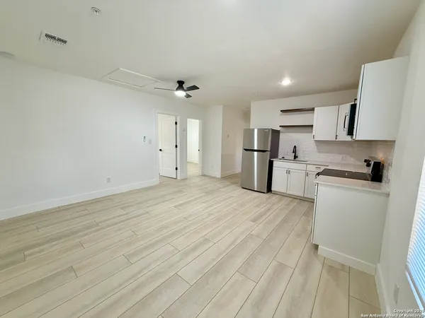 a view of kitchen with wooden floor and electronic appliances