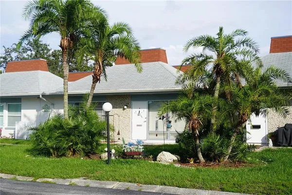 a front view of a house with a garden and plants