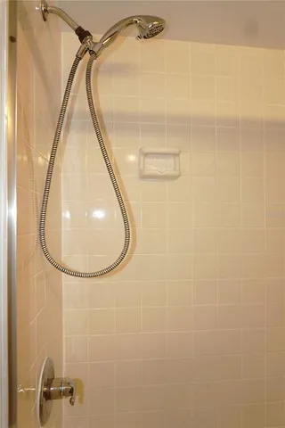 a bathroom with a mirror and shower