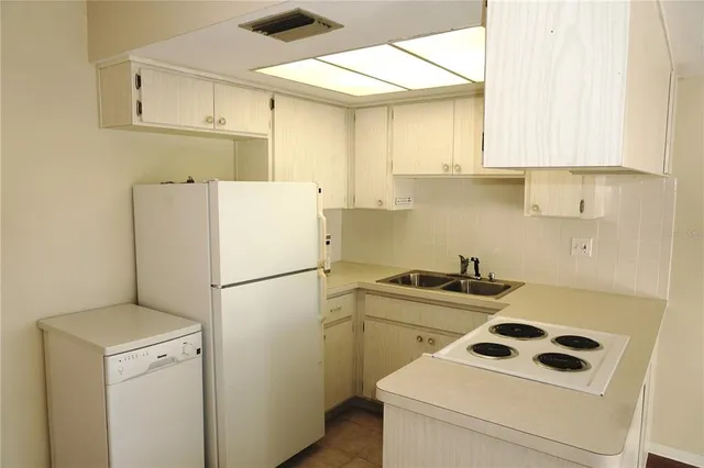 a white refrigerator freezer sitting inside of a kitchen