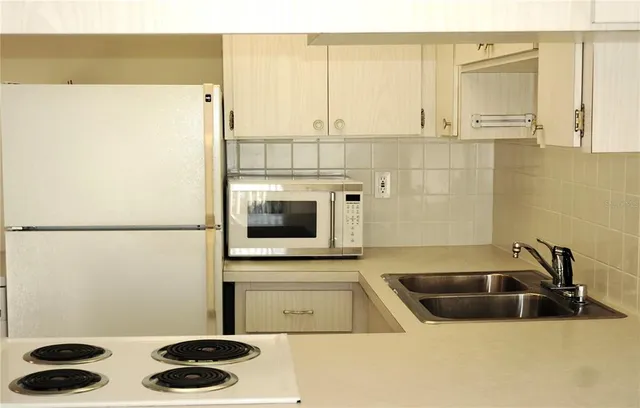 a kitchen with a refrigerator and a sink