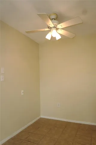 en empty room with a fan and fan