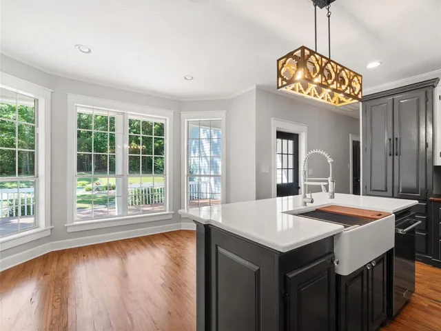 a kitchen with a table and a large window