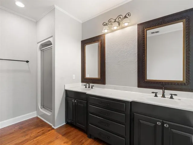 a bathroom with a double vanity sink and a mirror