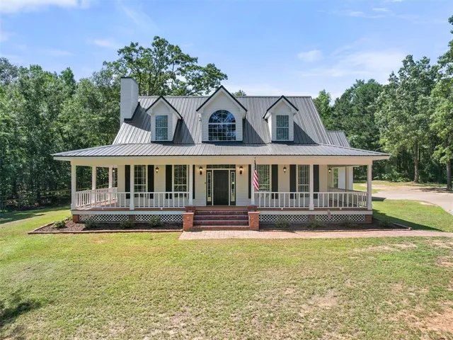 a front view of a house with a yard table and chairs