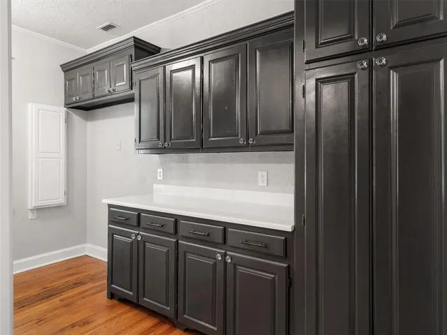 a kitchen with stainless steel appliances granite countertop a refrigerator a sink and dishwasher with wooden cabinets