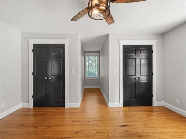 a bathroom with a granite countertop sink mirror vanity and a bathtub