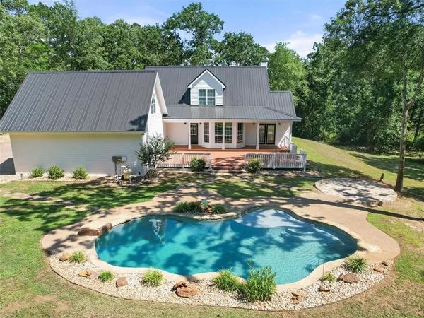 a view of a swimming pool and a yard