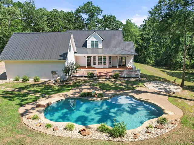 a view of a swimming pool and a yard