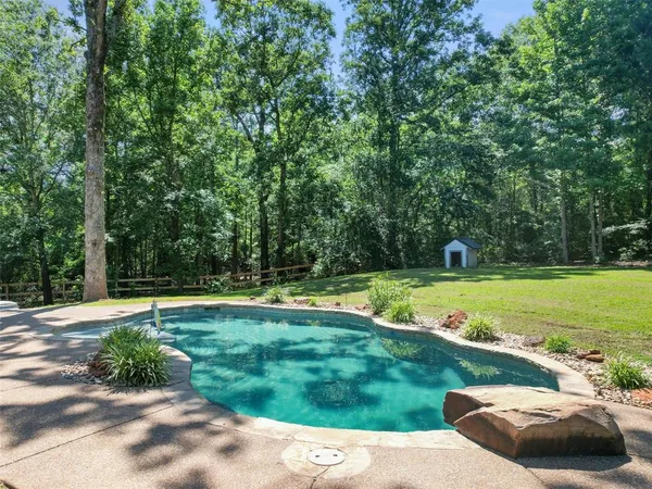 a view of a yard with wooden fence