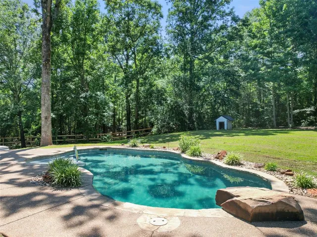 a view of a yard with wooden fence