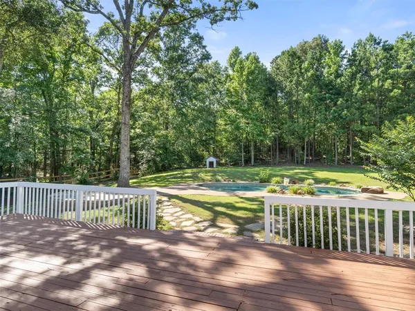 a front view of a house with a garden and plants