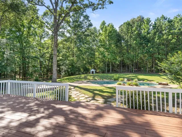 a front view of a house with a garden and plants