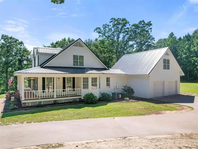 a view of a house with a yard and deck
