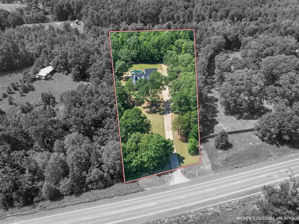 an aerial view of residential house with outdoor space