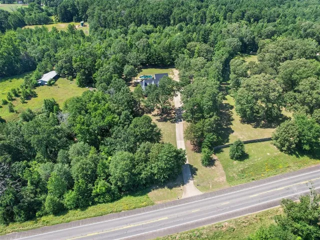 an aerial view of a house with yard