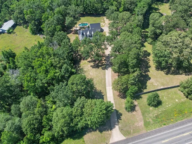 an aerial view of a house with yard swimming pool and outdoor seating